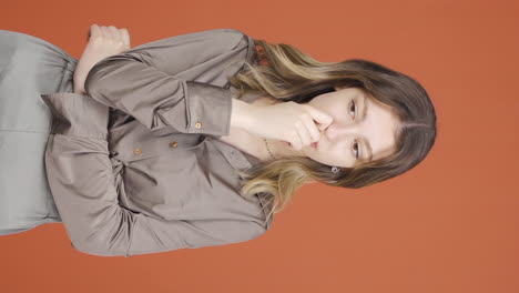 Vertical-video-of-Young-woman-looking-depressed-at-camera.